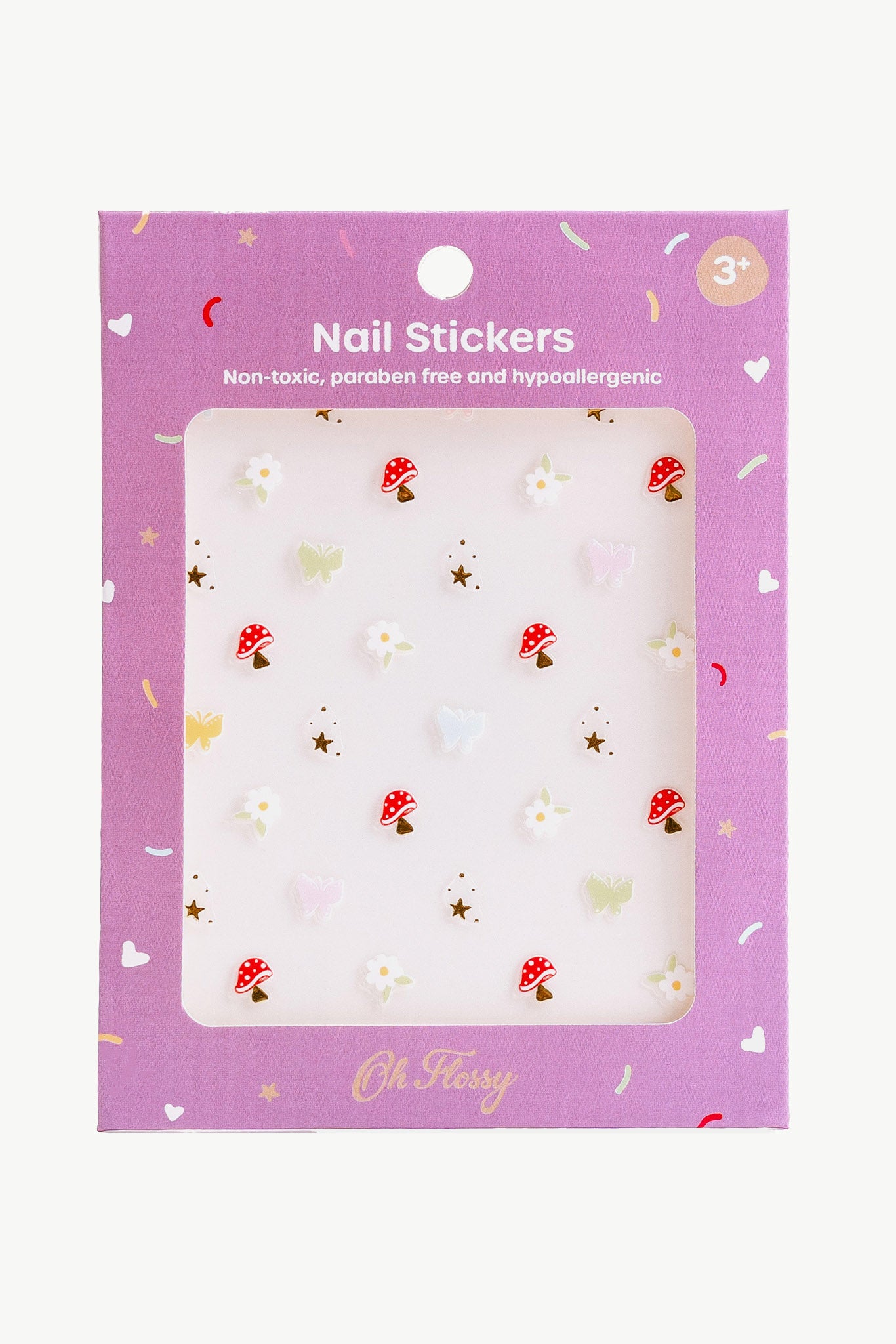 The "Oh Flossy ~ Nail Stickers Magical Garden" has a purple package and features red mushrooms, white flowers, and pink hearts. The non-toxic, paraben-free, hypoallergenic stickers are great for inspiring creativity in kids aged 3 and up.