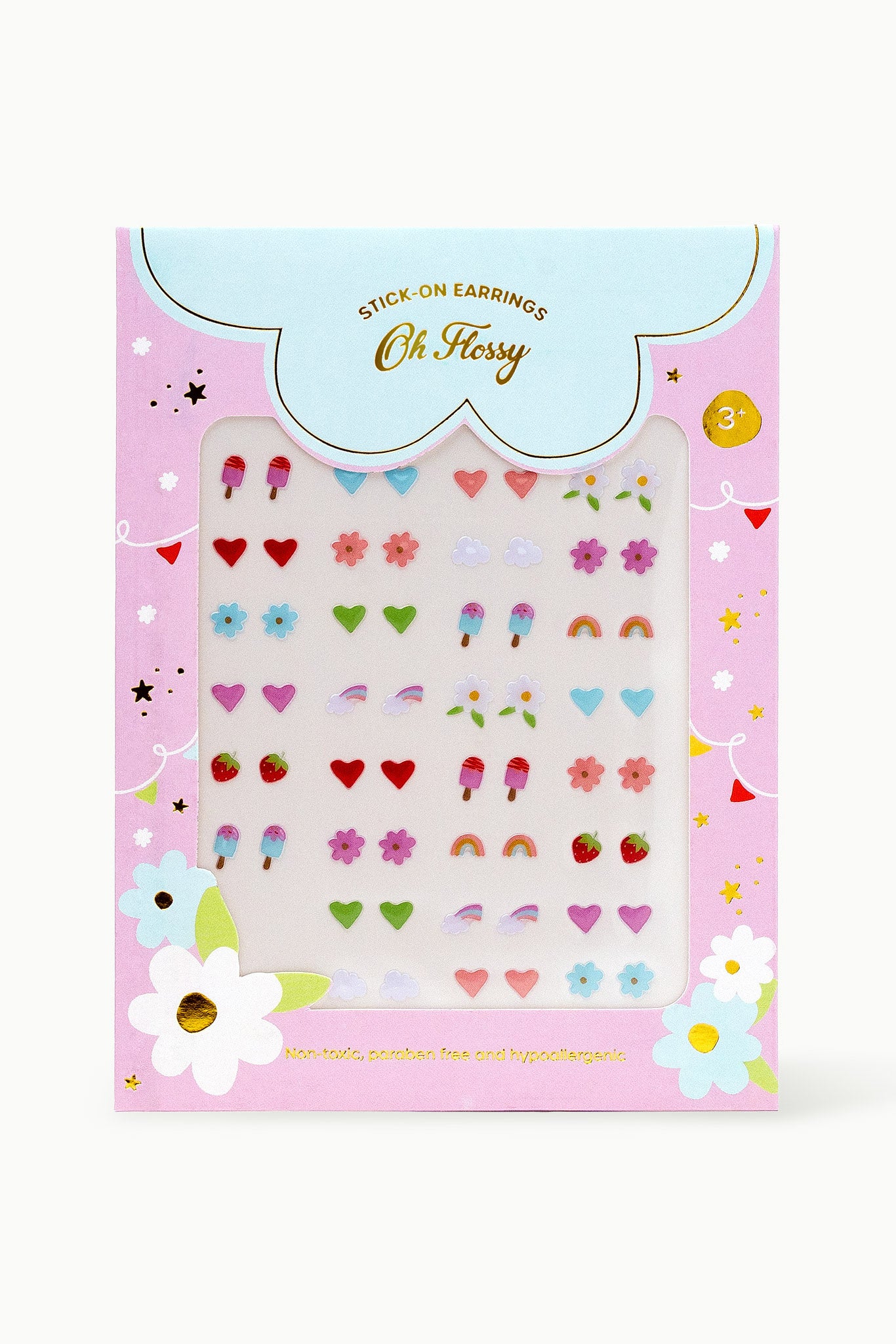 The "Oh Flossy ~ Kids Stick-On Earrings" by OH FLOSSY feature 36 pairs of non-toxic, colorful designs like hearts, stars, flowers, rainbows, and ice creams. The packaging is decorated with festive banners and flowers.
