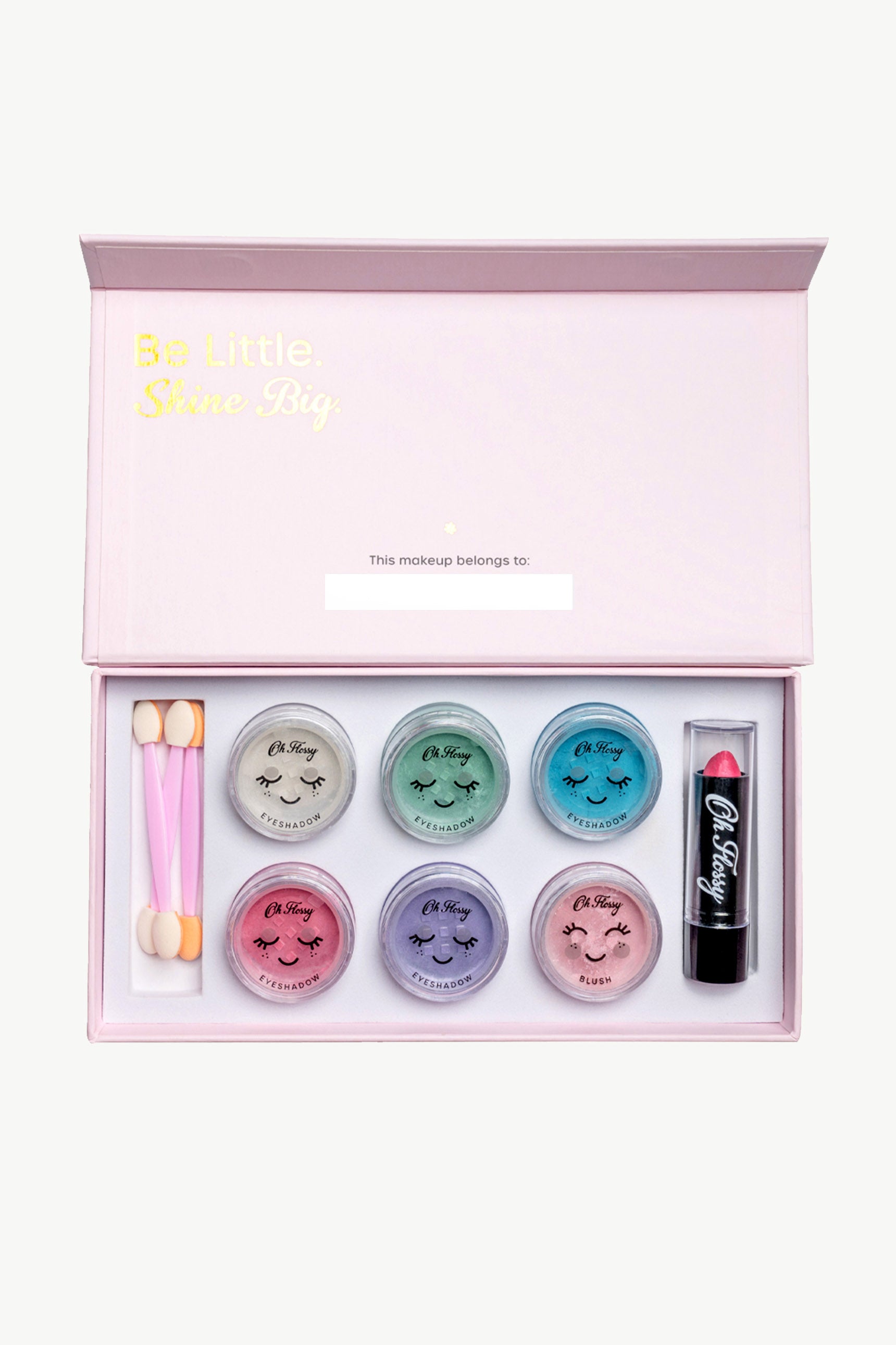 The "Be Little. Shine Big." OH FLOSSY open pink makeup box features the Oh Flossy ~ Deluxe Makeup Set, complete with five pastel eyeshadow containers, a lipstick, and two dual-ended sponge applicators for enjoyable and non-toxic play.