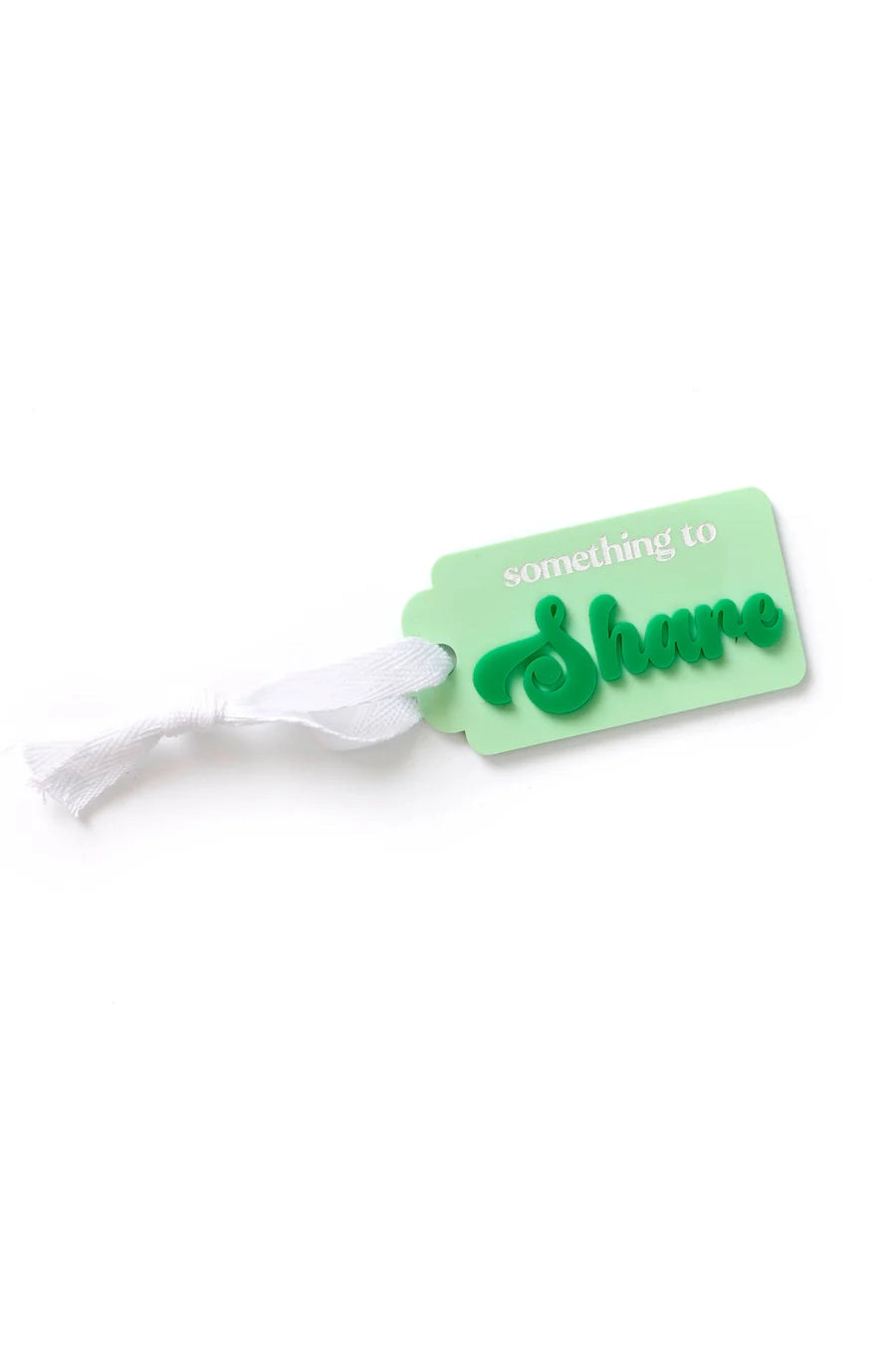 A green acrylic tag from HELLO KIT CO, named "Something to SHARE Tag Greens," comes with a white ribbon. The tag is embossed with the phrase "something to Share," displaying "Share" in raised green letters, making it a thoughtful choice for gifting.