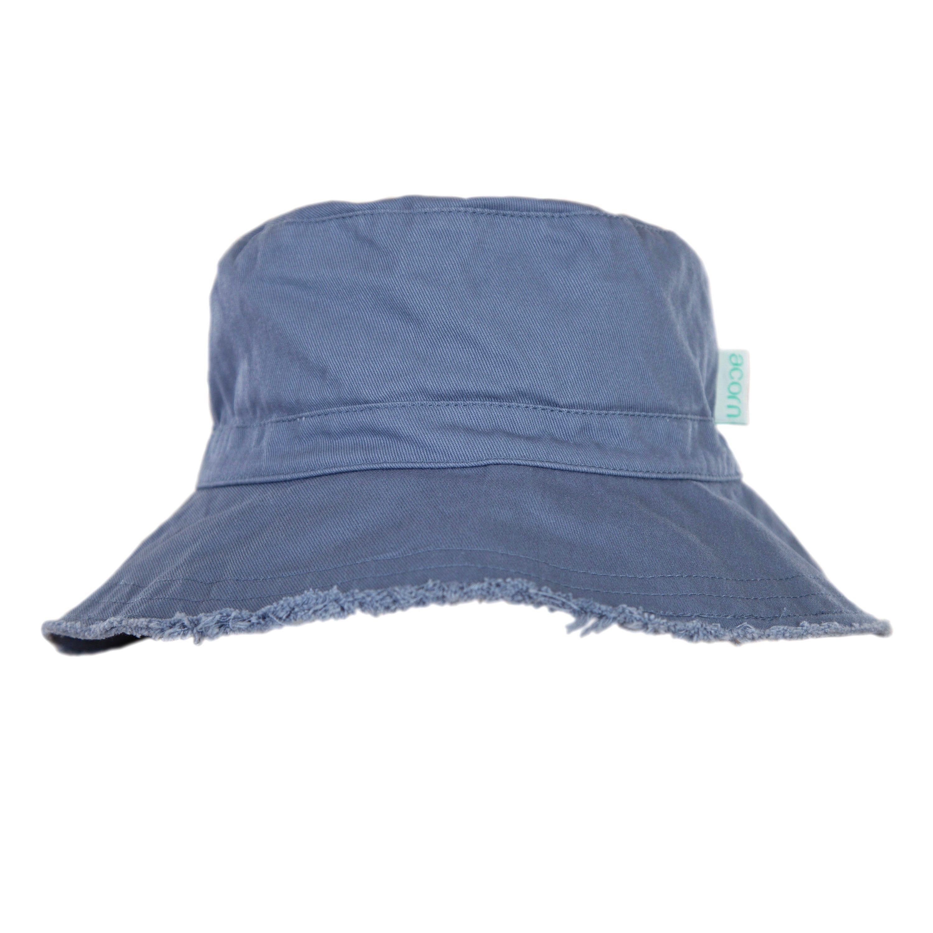 The Frayed Bucket Hat Blue by ACORN KIDS is a blue denim bucket hat featuring a frayed edge and a small green tag on the side. Made of durable cotton twill, it offers UPF50+ sun protection while maintaining its simple design.