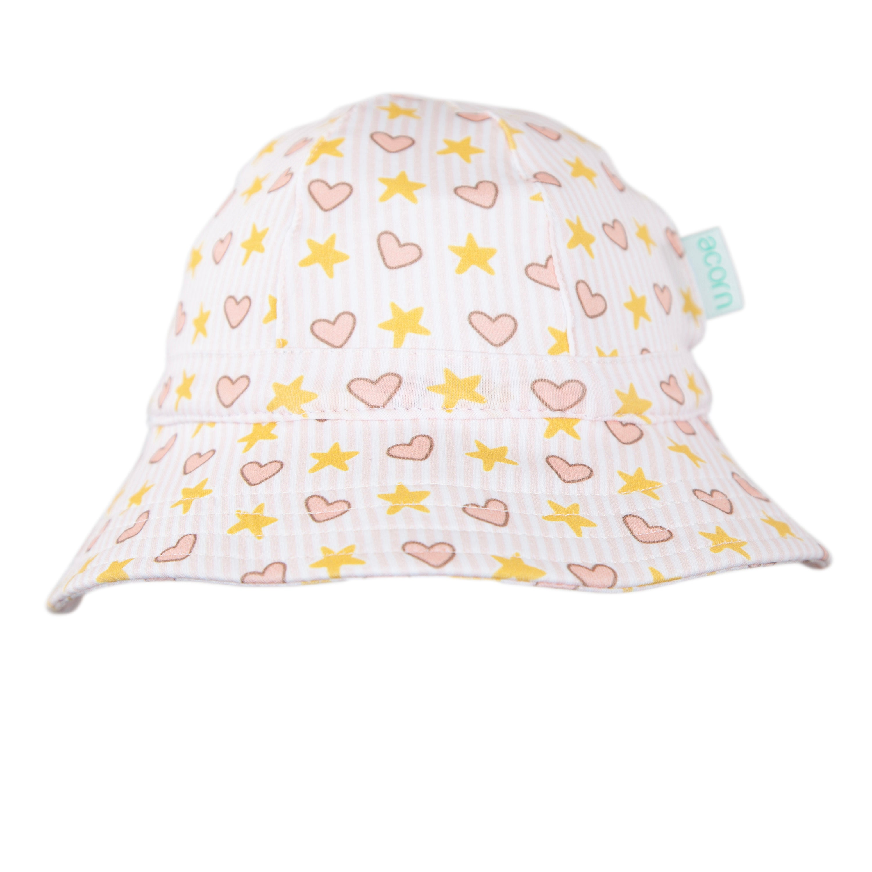 The ACORN KIDS Love and Stars Stretch Cotton Wide Brim Sunhat features a white background with yellow stars and pink hearts, UPF50+ sun protection, light pink brim, and a small sewn-on side tag.