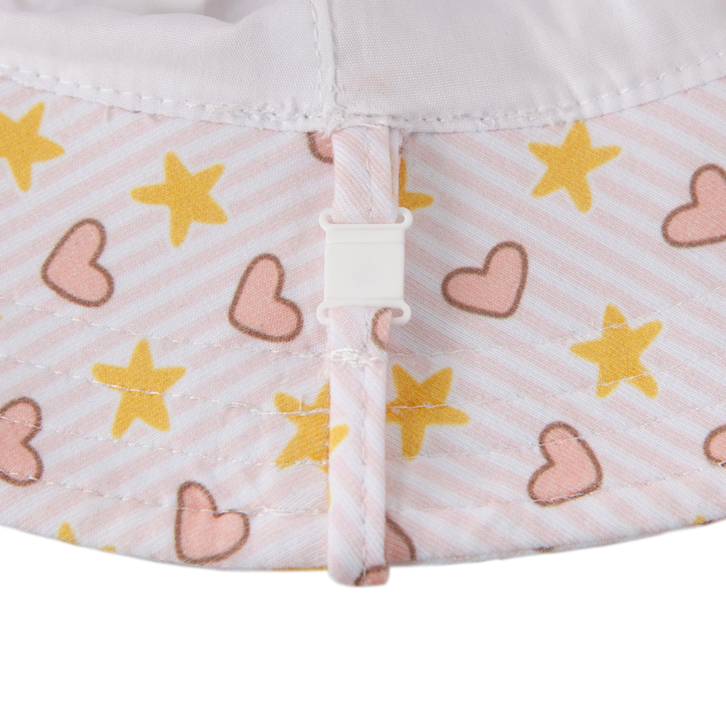 Close-up of ACORN KIDS Acorn Kids - Love and Stars Stretch Cotton Wide Brim Sunhat, made from light pink cotton jersey with diagonal stripes, yellow stars, and pink hearts, plus a white buckle—offers UPF50+ sun protection.