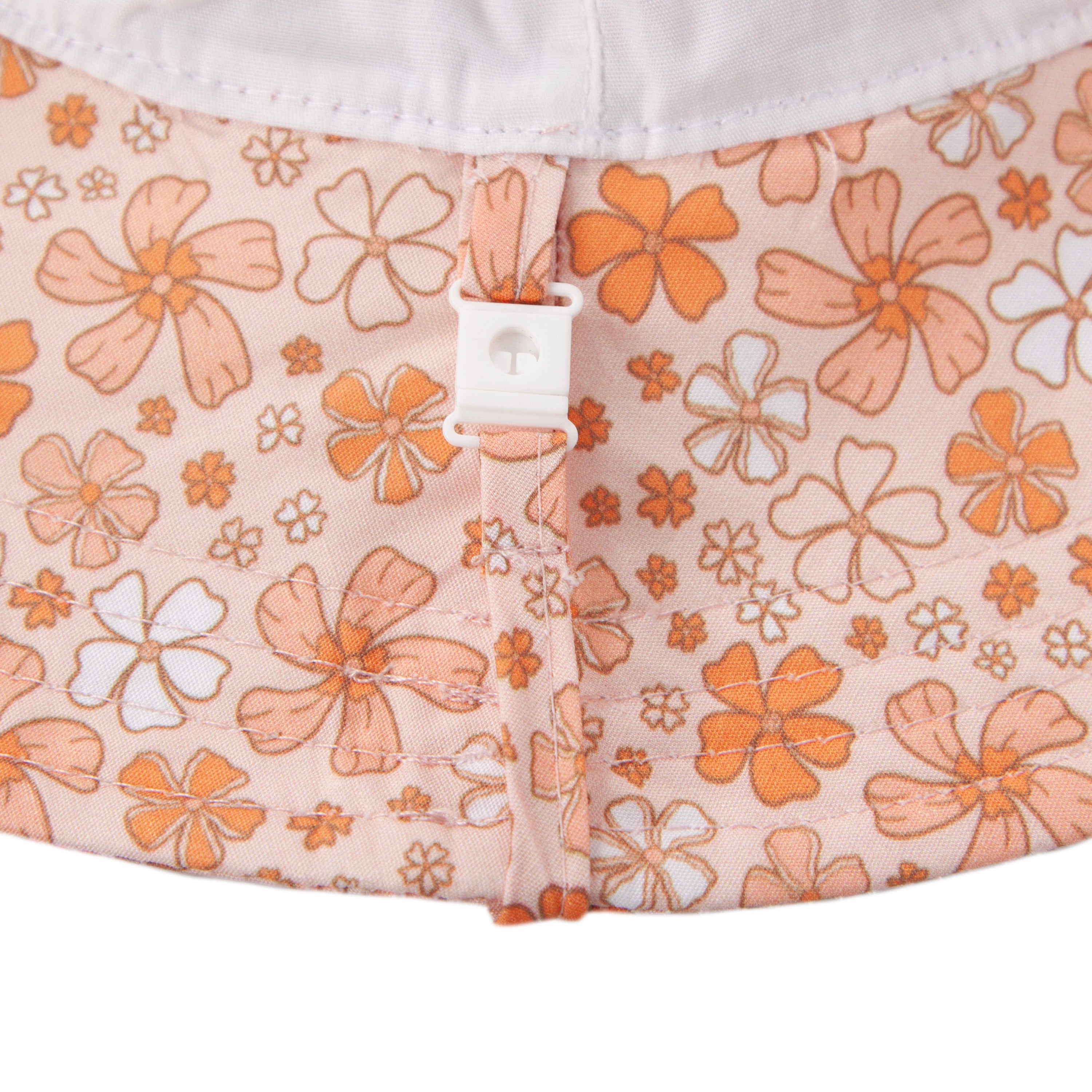 Close-up of the Acorn Kids - Lulu Wide Brim Sunhat by ACORN KIDS, in pink with an orange and white vintage floral print, featuring a small white adjustable toggle at the back for sizing.