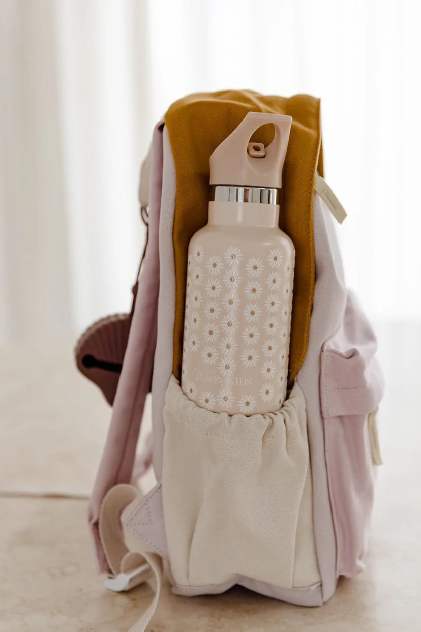 A side view of the pastel Poppy Backpack by ZEPHII with a beige floral-patterned water bottle in its side pocket, displayed on a light surface.