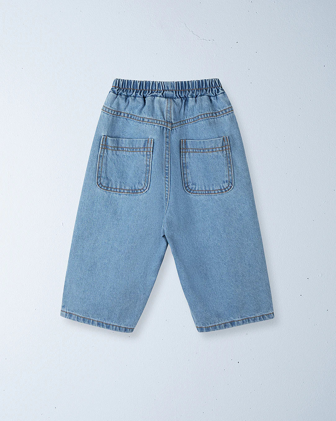 ZIGGY ZAZA’s Ziggy Zaza - Suki Denim Jean Light Wash Denim shorts feature an elastic waist and two back pockets—ideal for fans of casual comfort and elastic waist jeans. Laid flat on a light gray surface.