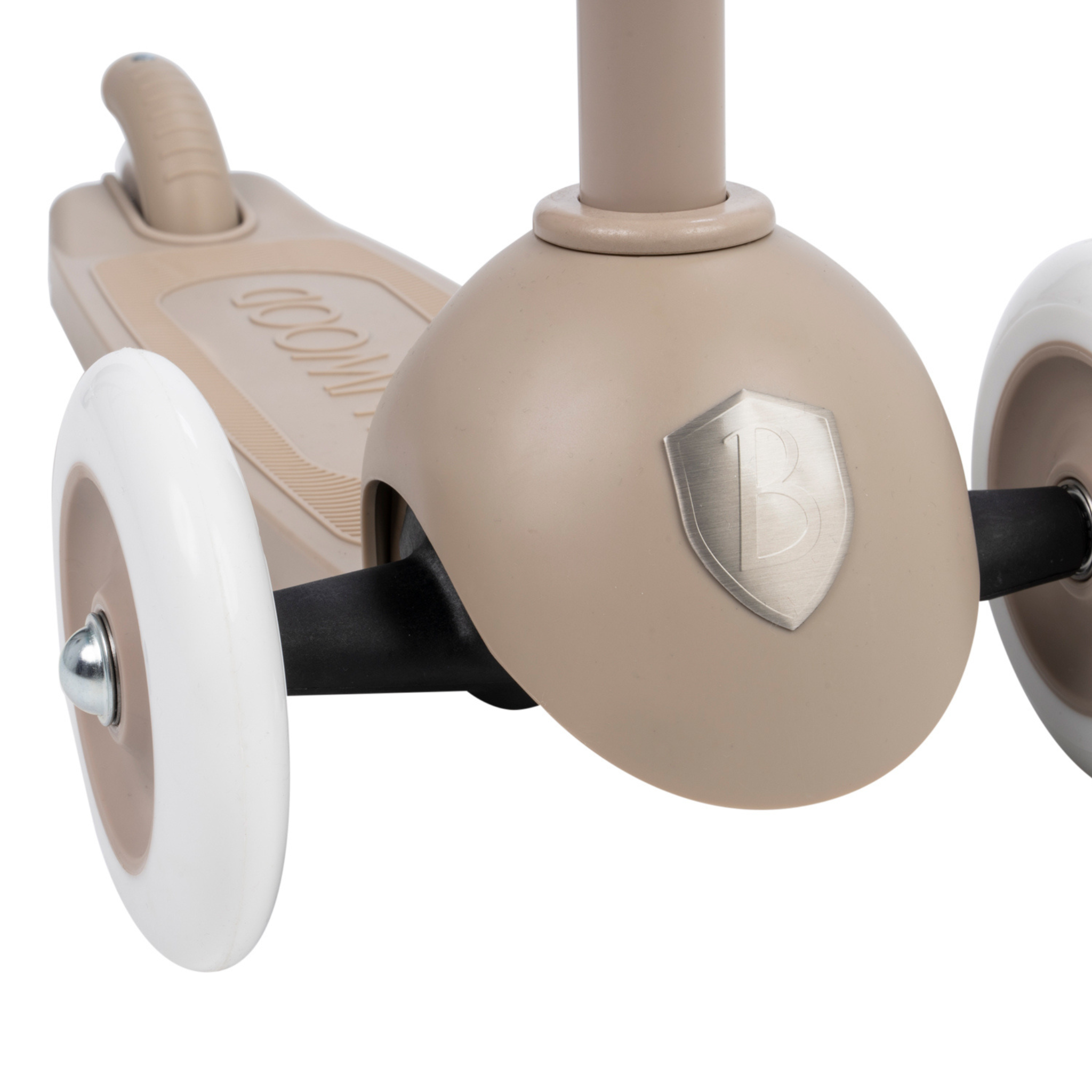 Close-up of the Banwood Eco Scooter Sand by BANWOOD, featuring an Easy Ride Steering System and white wheels. A metallic "B" shield decorates its front. The deck is crafted from post-consumer recycled plastic, is textured, and comes with a looped rear brake.