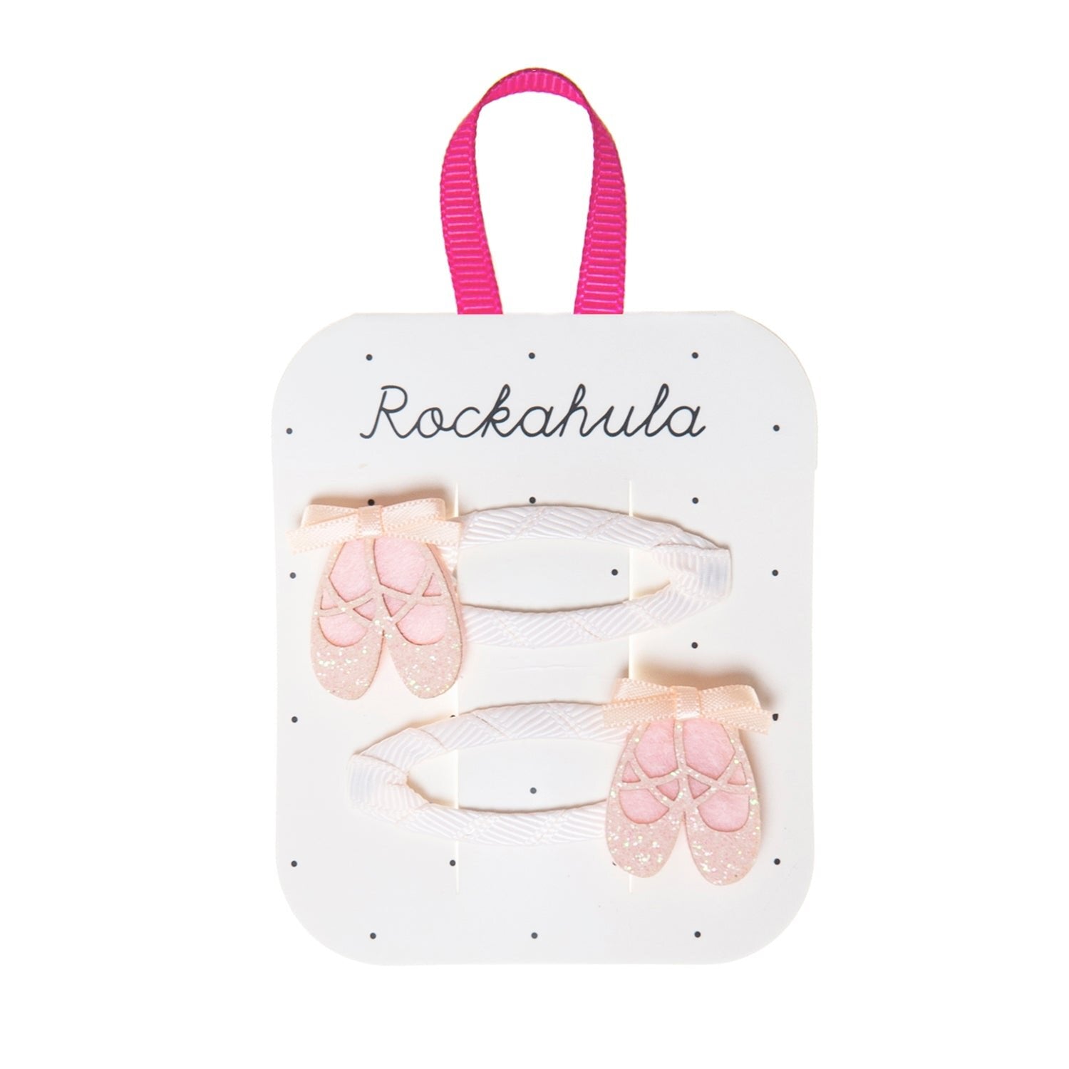 Rockahula - Ballet Shoes Clips by ROCKAHULA: Set of two white snap clips with pink glitter ballet shoes and bows, presented on a white Rockahula card with a pink loop at the top.