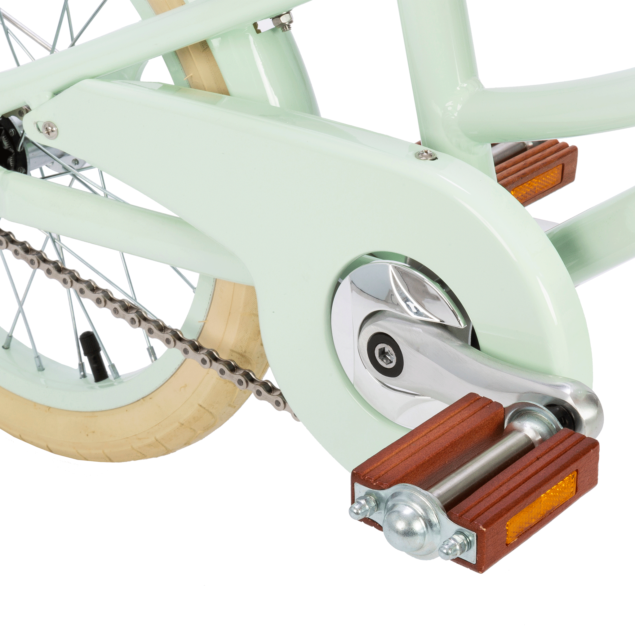 A close-up of the Banwood Classic Bicycle in Pale Mint showcases its vintage charm, focusing on the rear wheel, drivetrain, chain, cream-colored tire, and brake system. Wooden pedals with reflectors enhance its Scandinavian design. The background is white, highlighting the BANWOOD brand's aesthetic.