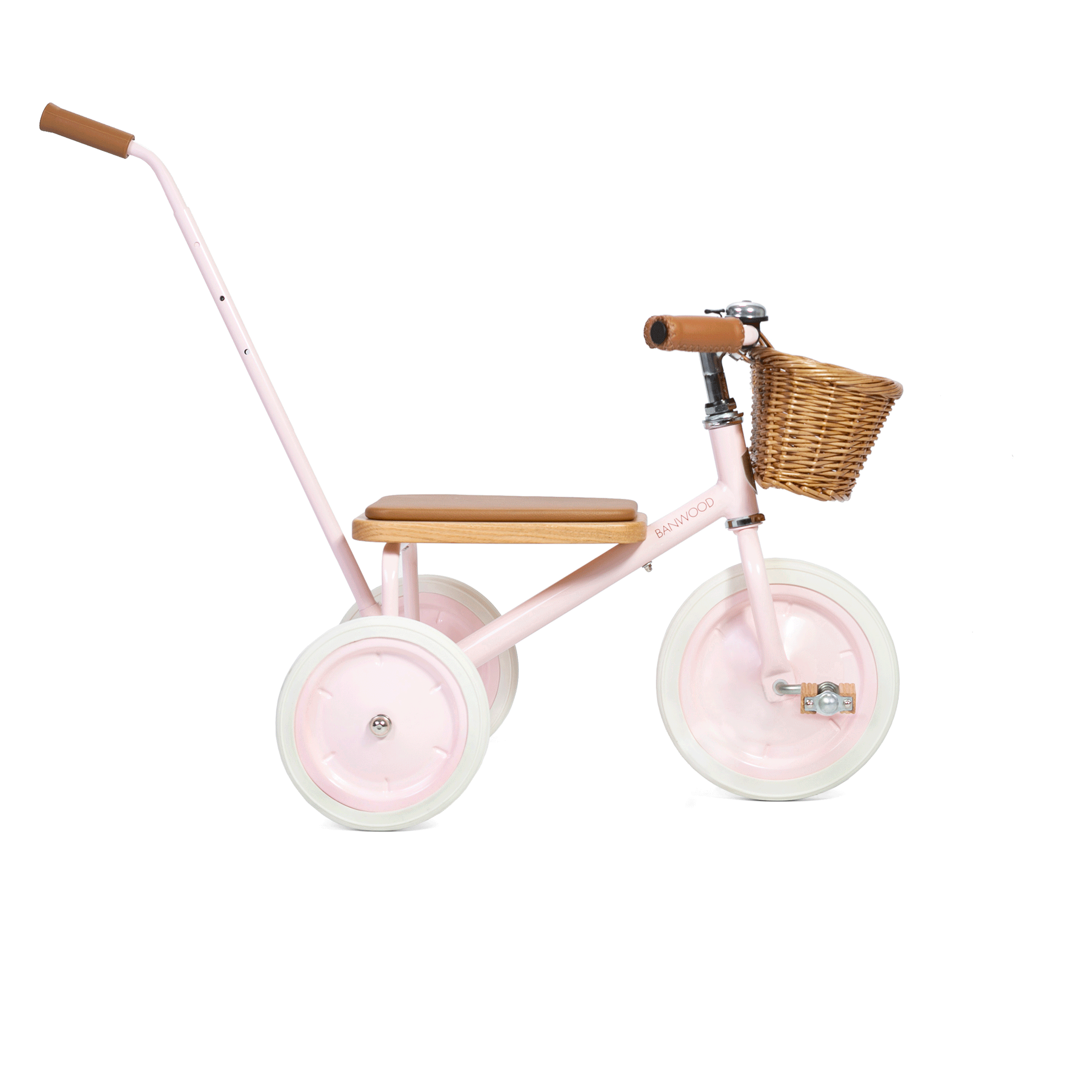 The Banwood - Trike Pink by BANWOOD is a charming kids' tricycle with a wooden seat and handlebar. It features a rear push handle, front wicker basket, and large white wheels, all set against a plain white background.