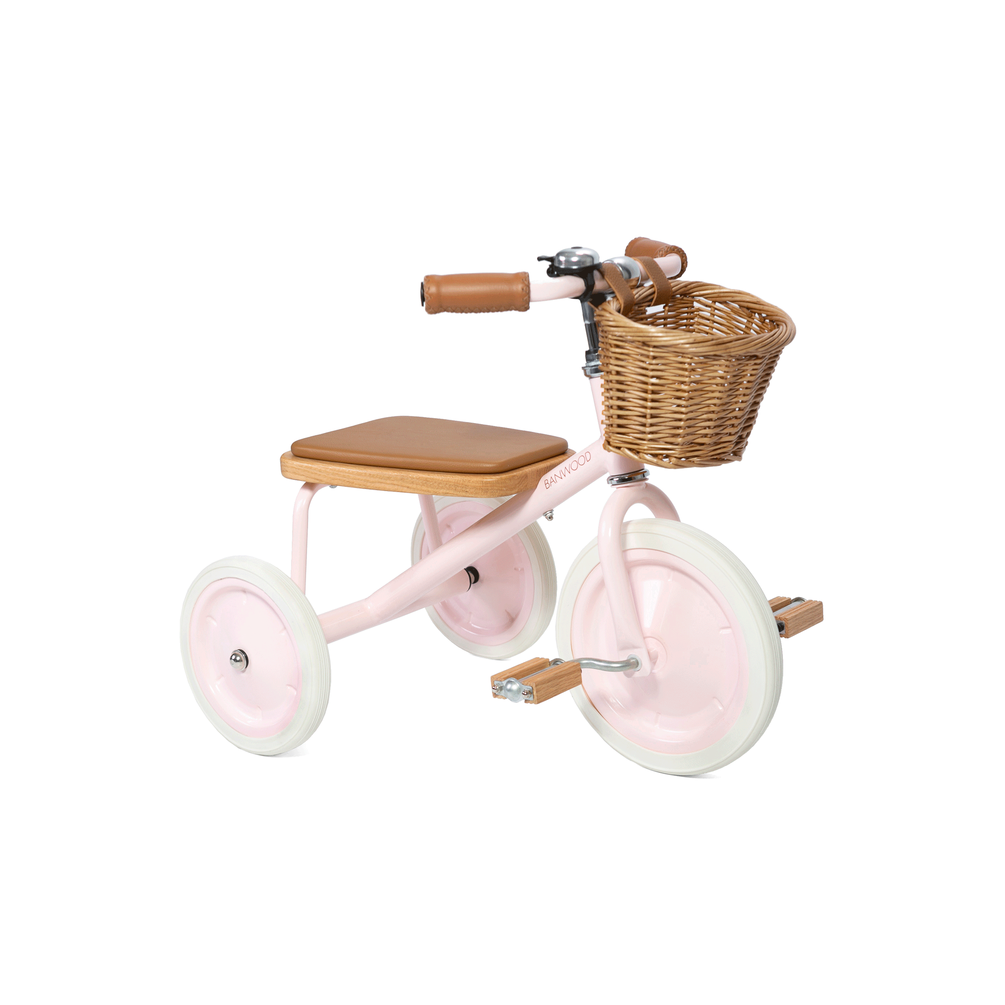 The Banwood - Trike Pink by BANWOOD is a delightful pastel pink tricycle for kids with white wheels, a tan seat, brown handlebars and pedals, and a classic wicker basket on the front.