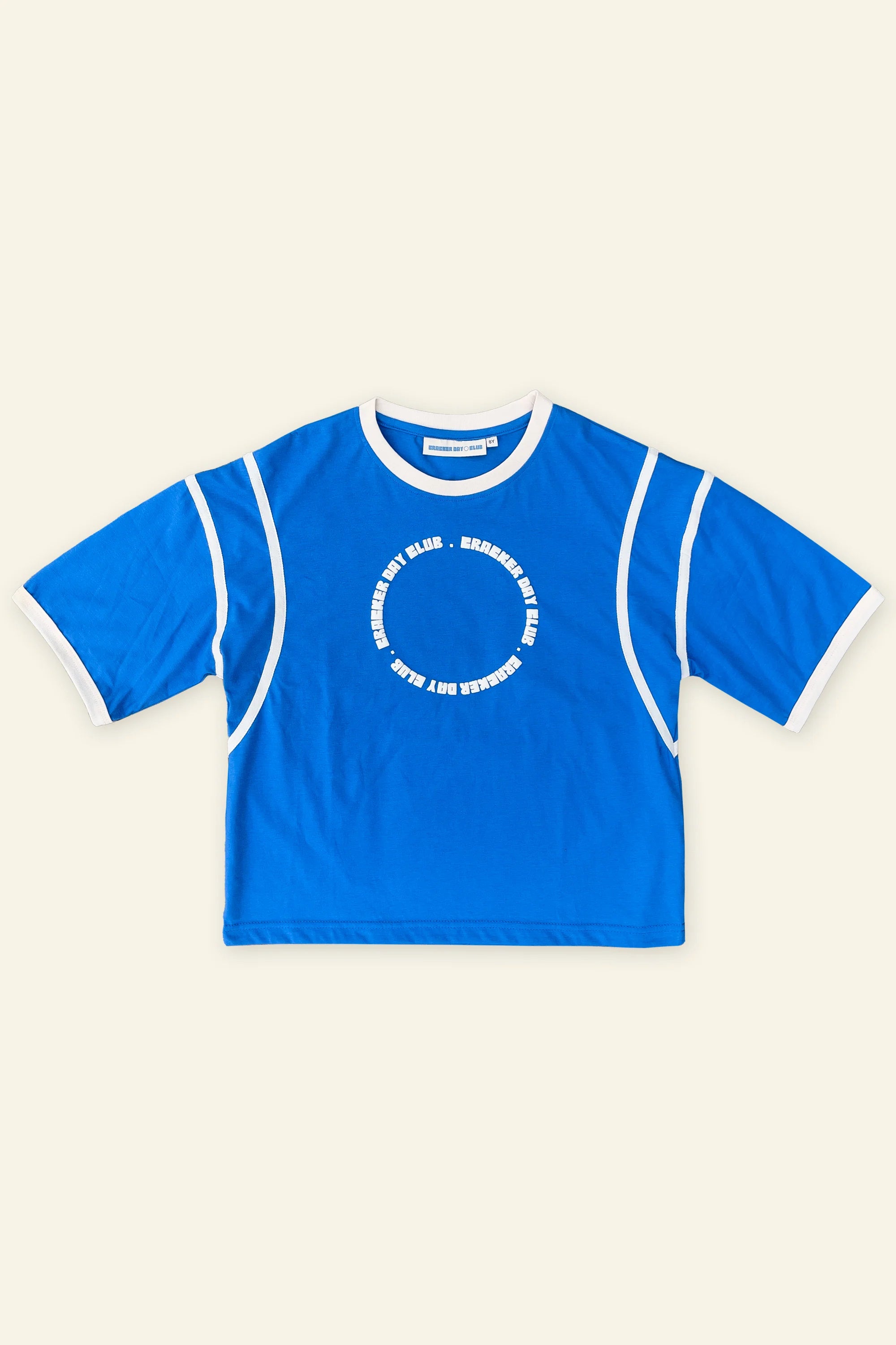 The CRACKER DAY CLUB Cracker Day Club - Kids Racer Club T-Shirt Blue features a boxy, relaxed fit and white trim on sleeves, collar, and seams with a central white circular text design, making it ideal for casual outdoor wear.