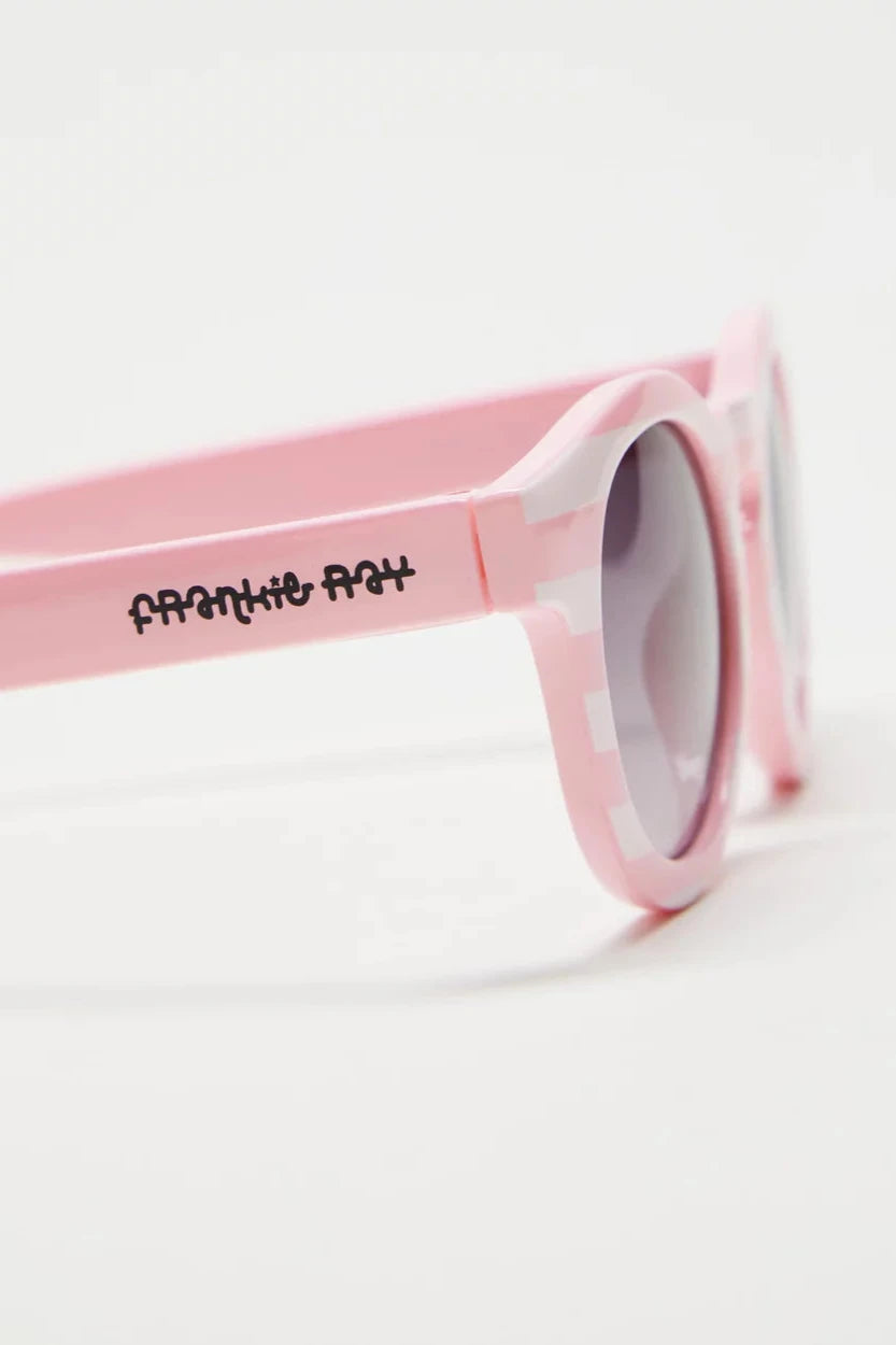 The Baby Pixie Sunglasses in Pink Stripe by FRANKIE RAY feature impact-resistant, dark lenses that provide 100% ultraviolet protection. The playful and youthful rubber frame is perfect for sunny adventures, with "FRANKIE RAY" stylishly scripted in black on the side.