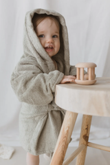 Little girl wearing the sage bath robe with hooded pulled up on her head