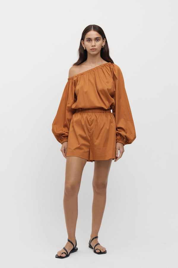 Front view of woman wearing Viviers Off Shoulder Top with matching shorts in marmalade.