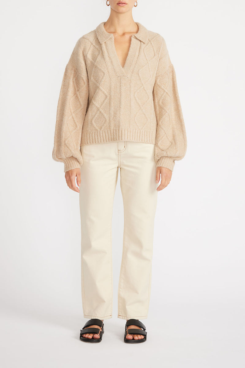 Front view of woman wearing Norma Collared Jumper in Natural with cream jeans