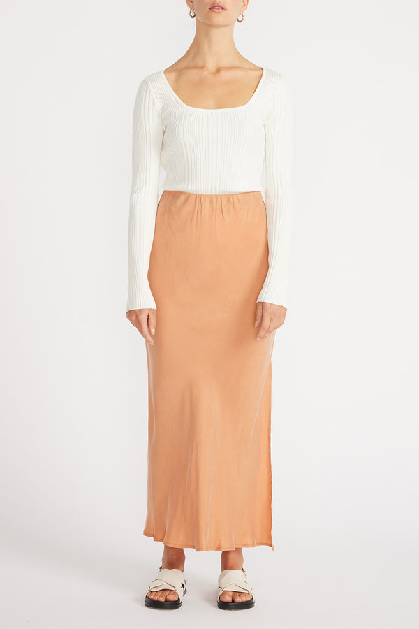 Front view of woman in white top and Elsie Cupro Skirt in Ginger.