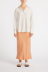 Front view of woman wearing Maya Oversized Shirt with slip skirt.