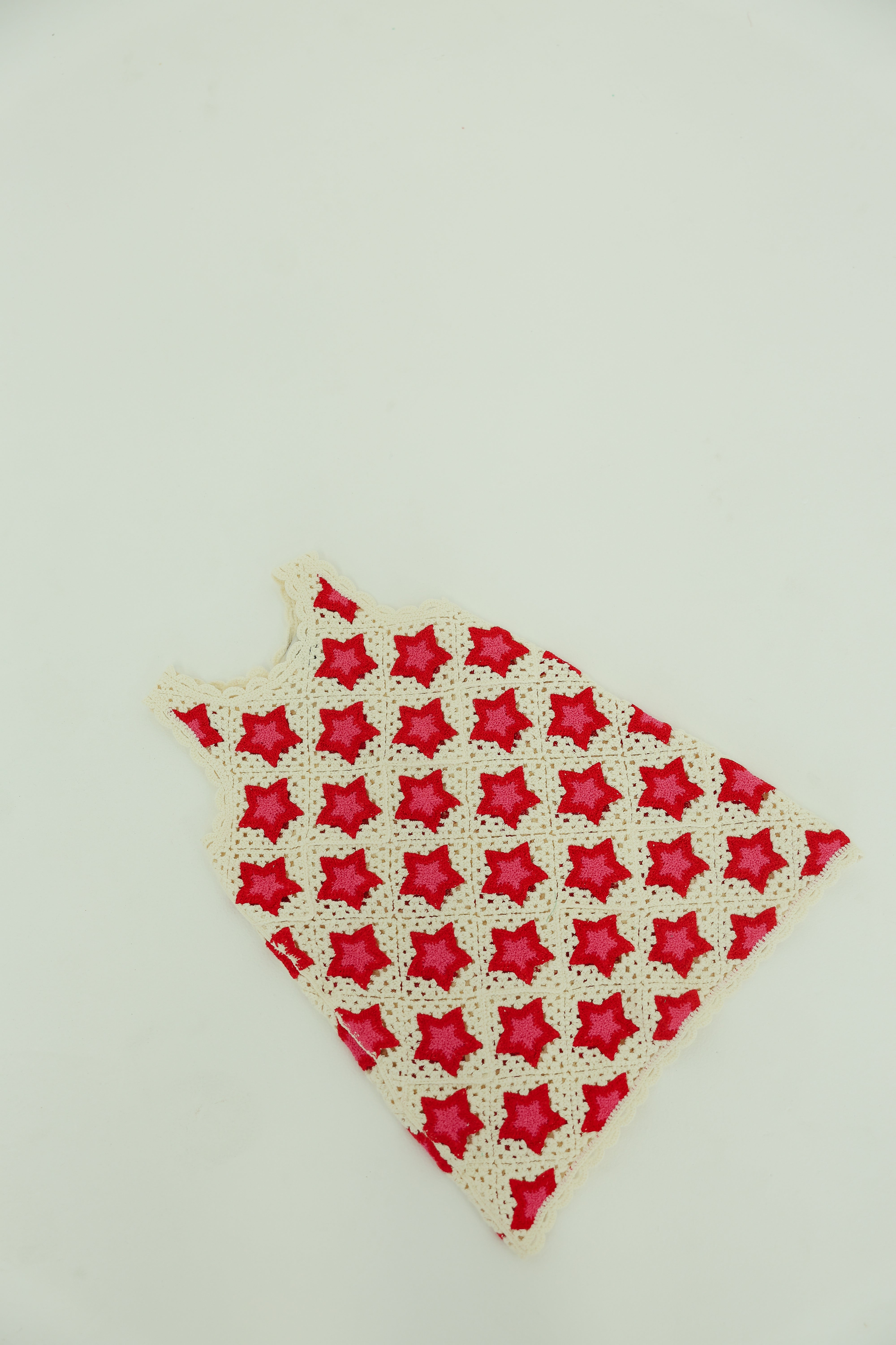 Red and white star-patterned dress on a light gray background
