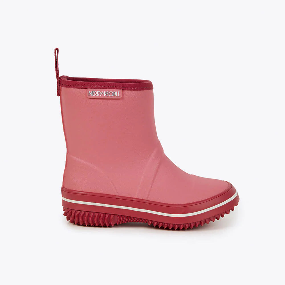 The Merry People ~ Andie Kids Gumboot Bubblegum is a pink waterproof ankle-high rain boot with a red sole/trim, featuring arch support, a textured sole for grip, and a pull tab at the back. The brand "MERRY PEOPLE" is on a small patch near the top.