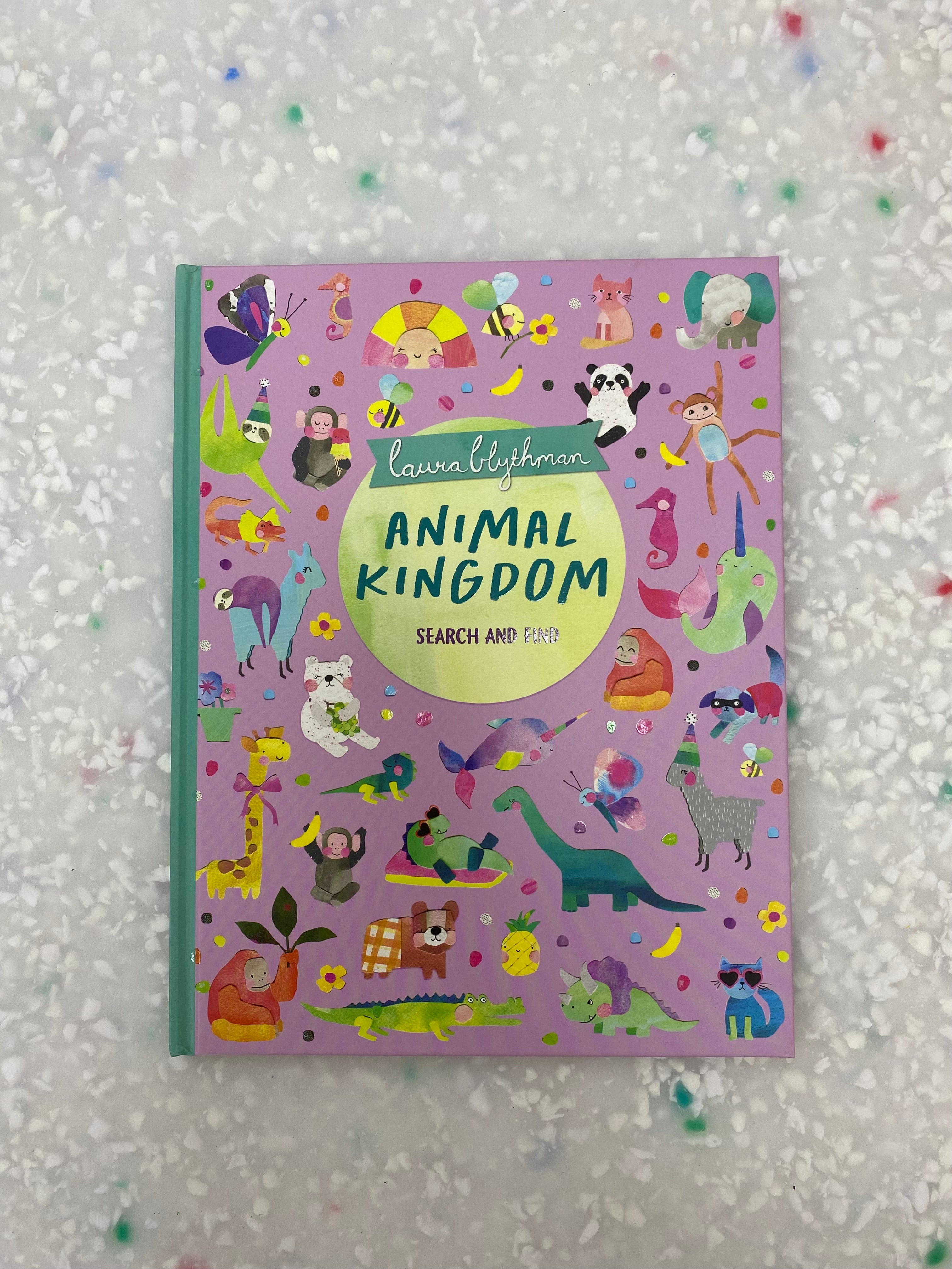 The book "Search And Find: Animal Kingdom" from BAY KIDS, authored by Laura Blythman, features a vibrant cover. A pink background is adorned with whimsical illustrations of quirky animals such as pandas, giraffes, and birds, set against a playful confetti-like backdrop.