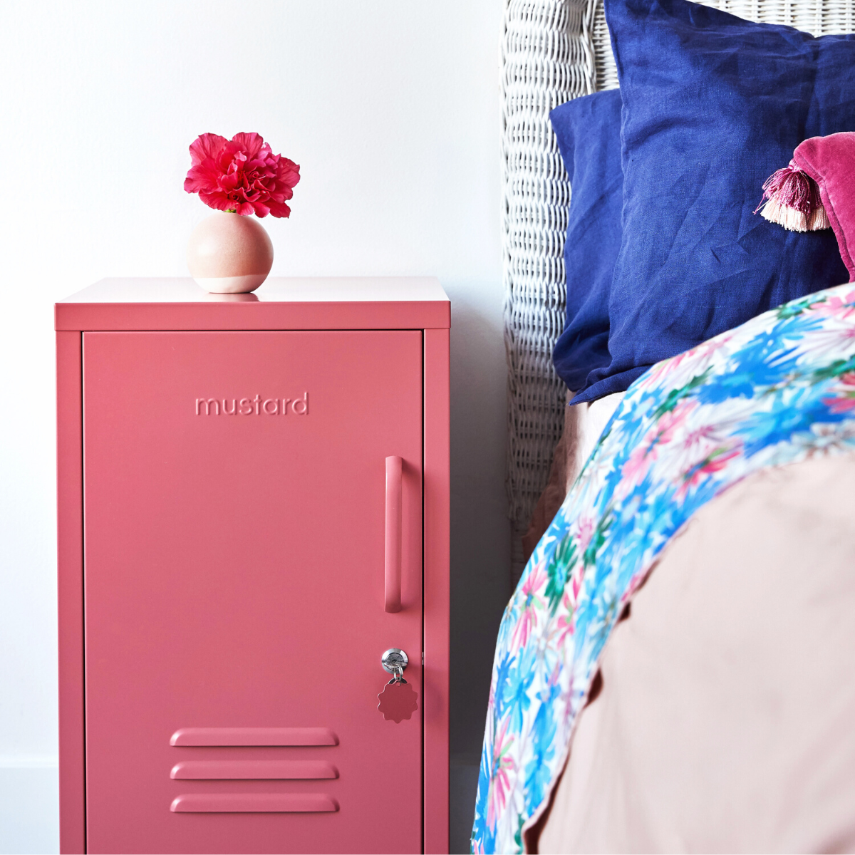 The shorty (to the left) locker in berry next to bed.