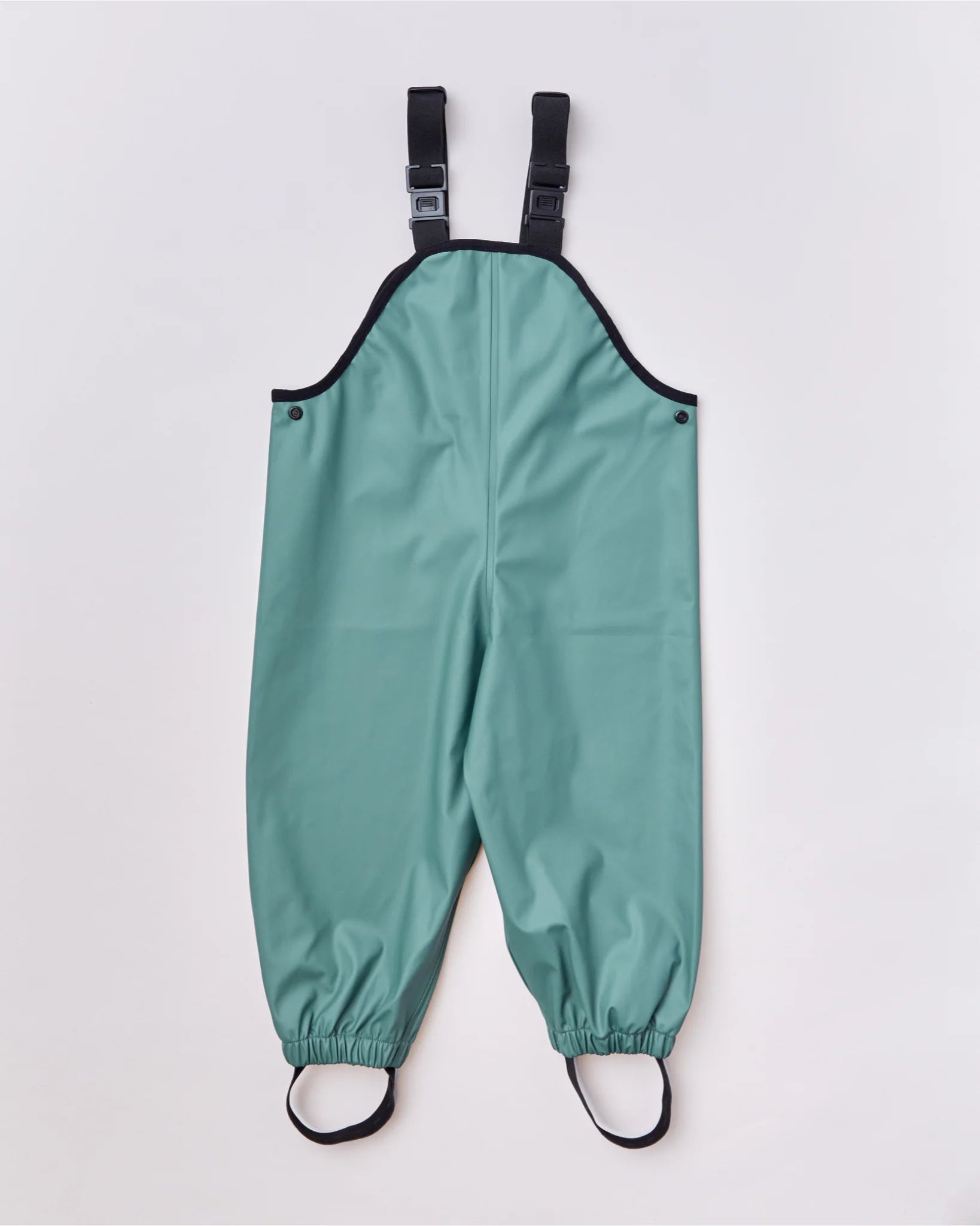 The Rainkoat ~ Waterproof Overalls Forest Green by RAINKOAT feature black adjustable straps and elastic ankle cuffs, ideal for rainy play. Displayed flat on a light grey background, they offer a practical front view for protective wear.