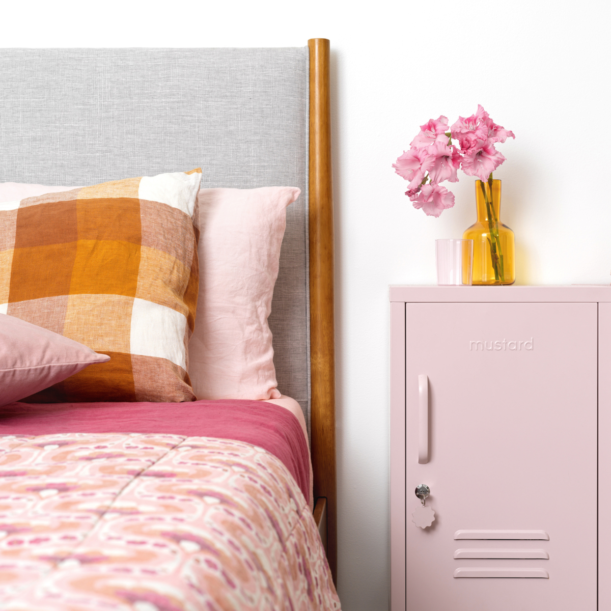 The shorty (to the right) locker in blush next to bed.