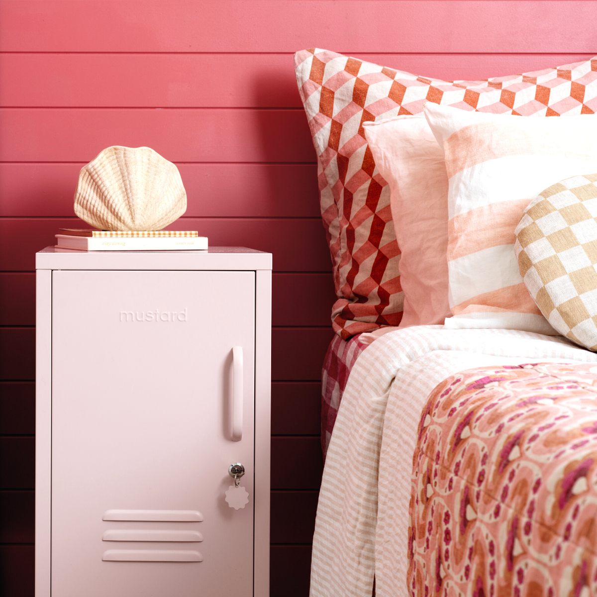 The shorty (to the left) locker in blush next to bed.