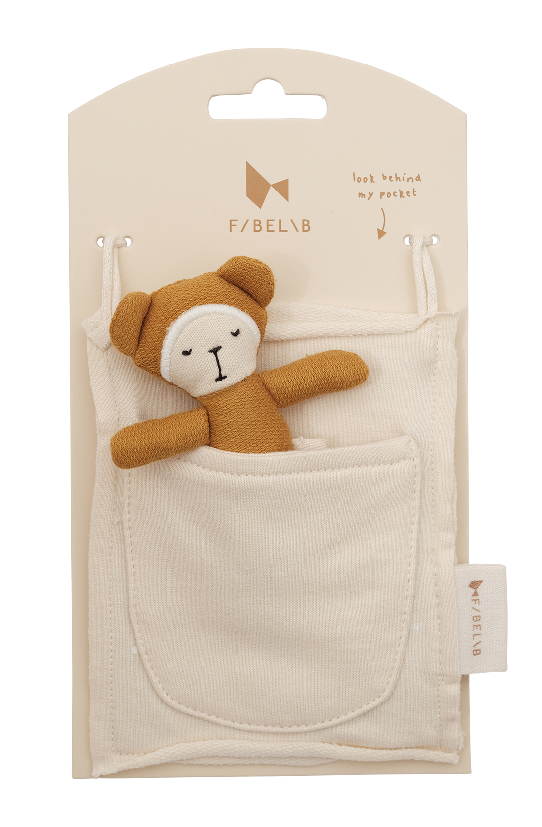 A small brown Bear Pocket Friend, crafted from organic cotton, peeks out from the pocket of a white fabric pouch. The pouch is attached to a beige product card with the brand name "FABELAB" printed on it. A message saying "look behind my pocket" reveals your new Pocket Friend.