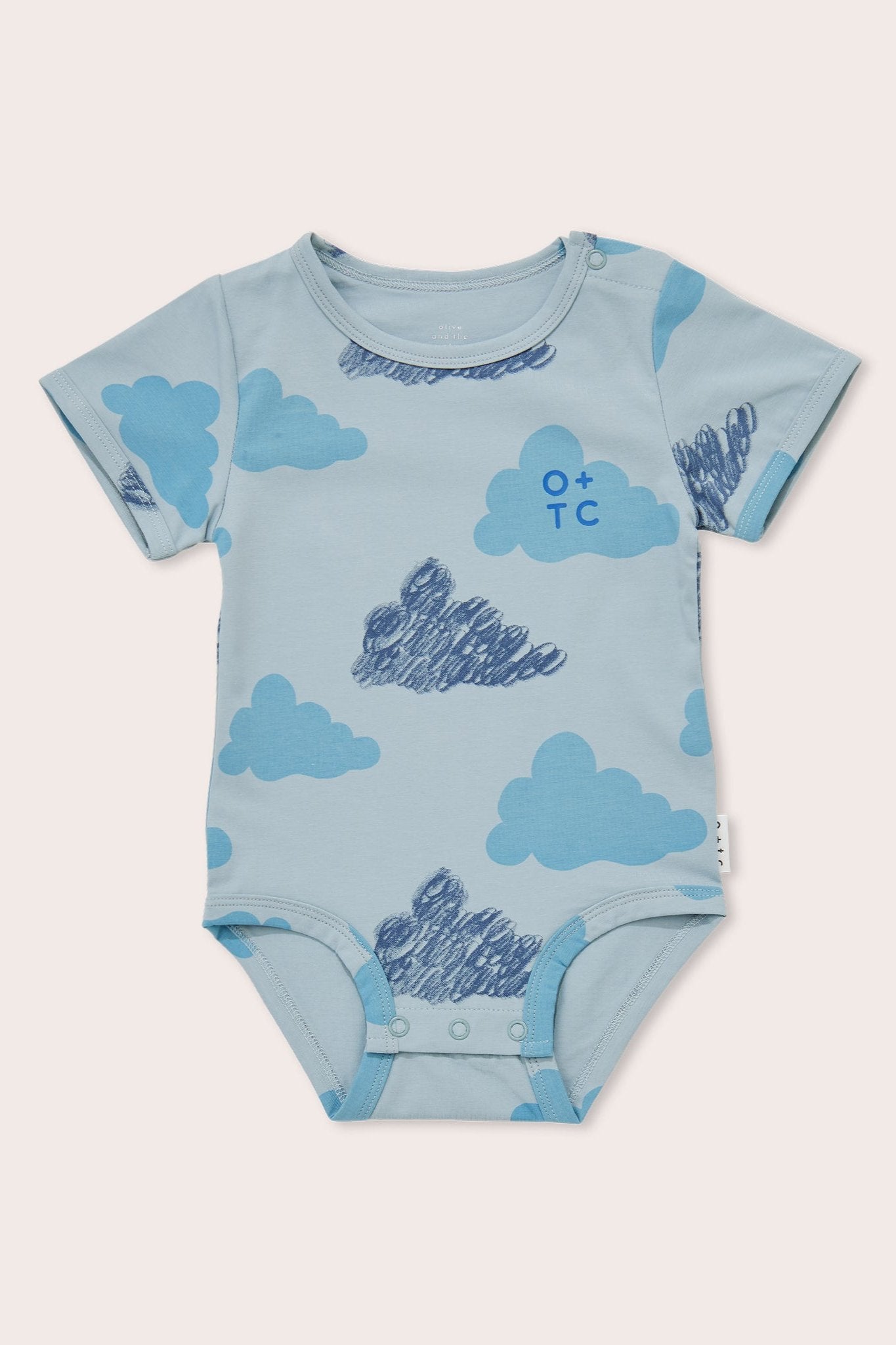 The Clouds Bodysuit by OLIVE + THE CAPTAIN is a light blue baby bodysuit with a short-sleeved design and snap closures at the bottom. Made of premium cotton, it features various crayon cloud prints and sports a small "O + TC" logo on the chest.