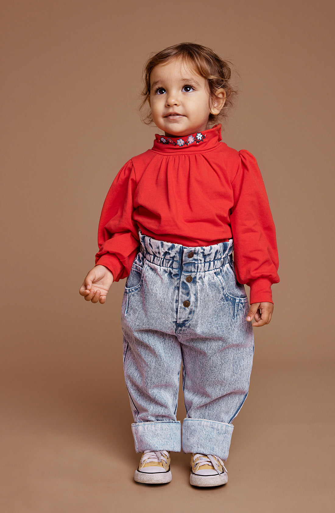 The millie paper bag jeans in light denim work by a little girl with red long sleeve top.