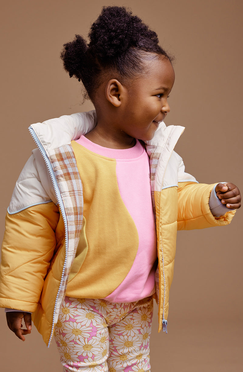 A young girl wearing the GOLDIE + ACE  Stevie Vintage Parka Golden/Marshmallow.