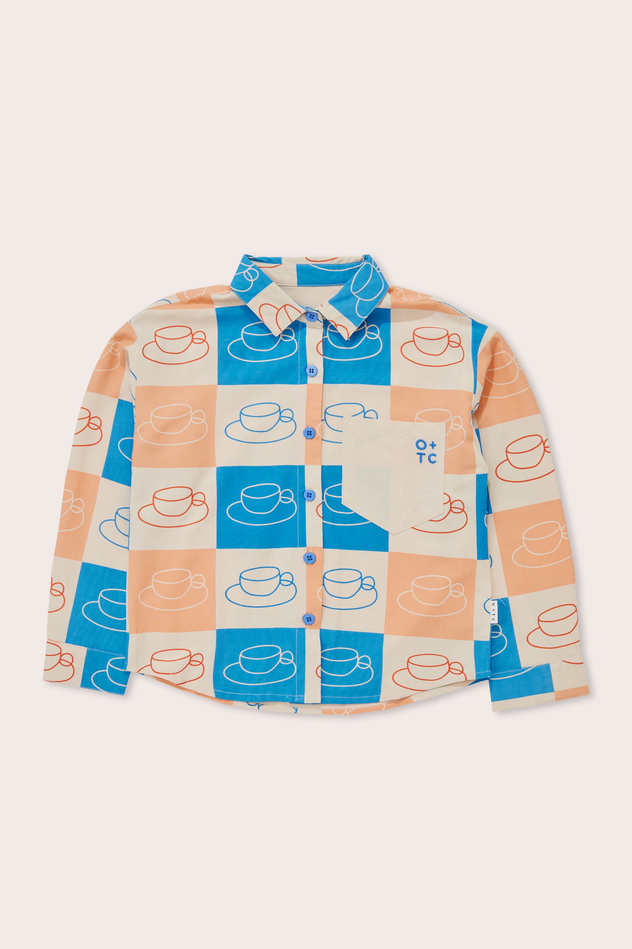 The Cups Button Down Shirt by OLIVE + THE CAPTAIN is a long-sleeve button-up featuring a colorful grid pattern of blue, orange, and beige squares. Each square showcases a stylized hat drawing. Crafted from a premium cotton linen blend, it includes blue buttons, a beige chest pocket with an emblem, and a beige collar. Enjoy its relaxed boxy fit for extra comfort.