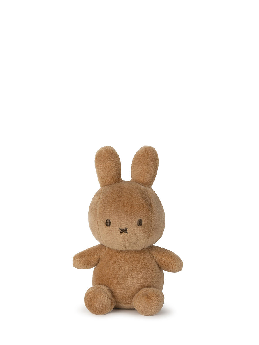 Introducing the Lucky Miffy in Giftbox Beige 10cm from BON TON TOYS X MIFFY: a charming, small, handcrafted plush toy made from recycled polyester. This adorable piece features round eyes and a minimalistic facial expression that resembles a rabbit with long ears. Believed to bring luck, the plush sits upright against a plain white background.