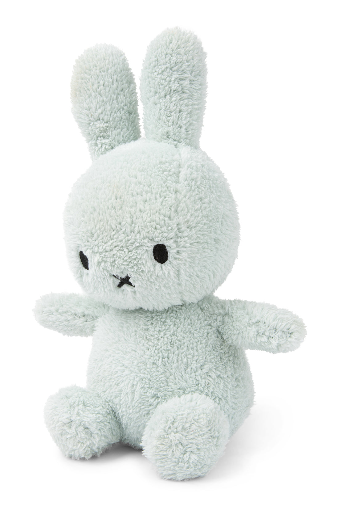 A mint green plush bunny toy from the BON TON TOYS X MIFFY collection, featuring recycled polyester filling, floppy ears, black eyes, and an "X" shaped mouth, sits upright against a white background. Perfect as a baby gift, this adorable item is part of the Miffy Terry Soft Green Collection and stands 23 cm tall.