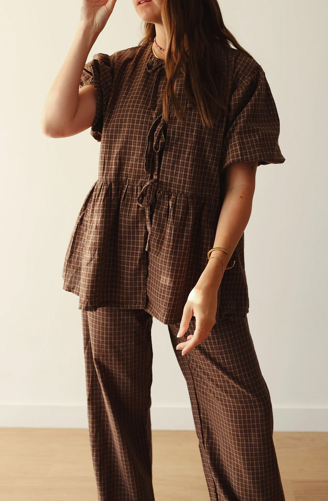 A women wearing the mama cami blouse and matching pant.