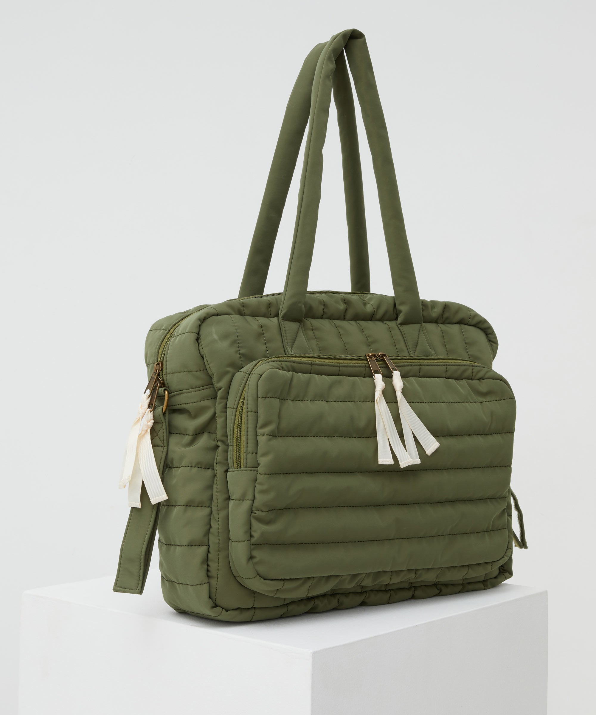 PHILÉ baby bag in khaki on a 45 degree angle.