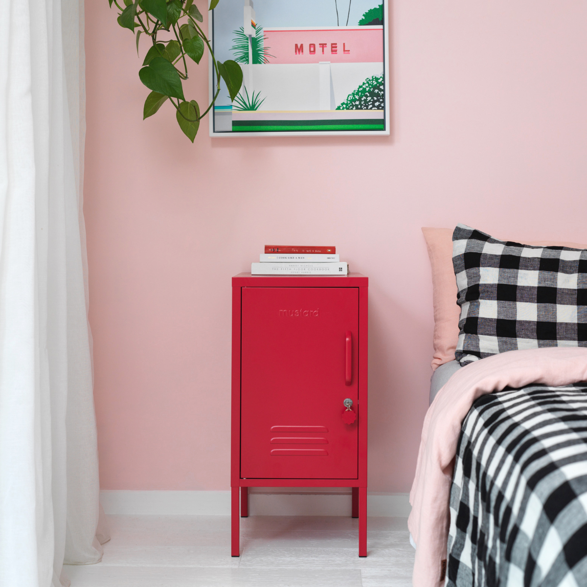 The shorty (to the left) locker in poppy next to bed.