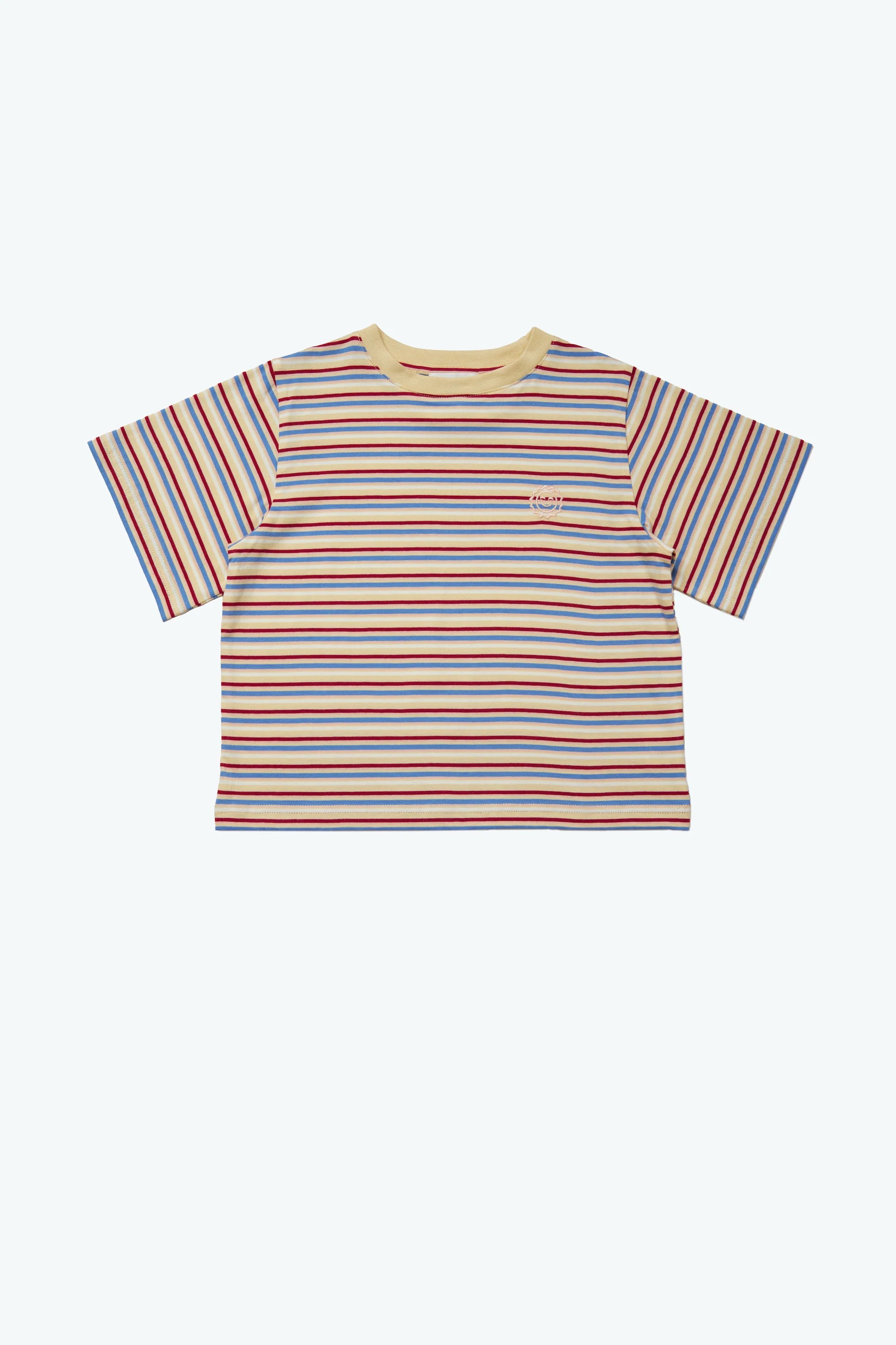 Introducing the Stripe Sloppy Tee from KOKOMO, an oversized tee featuring short sleeves and vibrant horizontal stripes in red, blue, yellow, and white. Crafted from organic cotton for comfort, it is highlighted by a light yellow collar and adorned with a small logo on the left chest. It stands out beautifully against a plain light background.