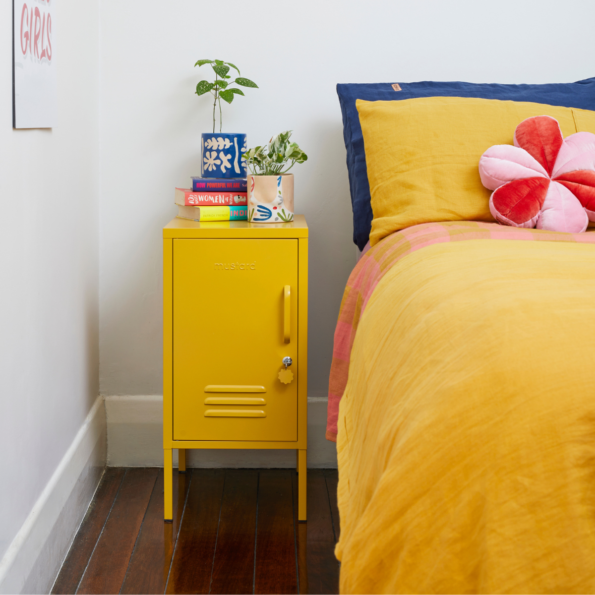 The shorty (to the left) locker in mustard next to bed