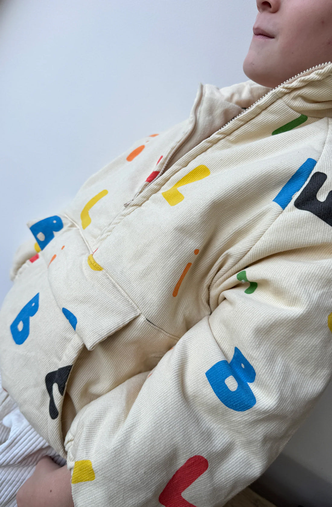 Boy wearing alphabet Joey jacket.