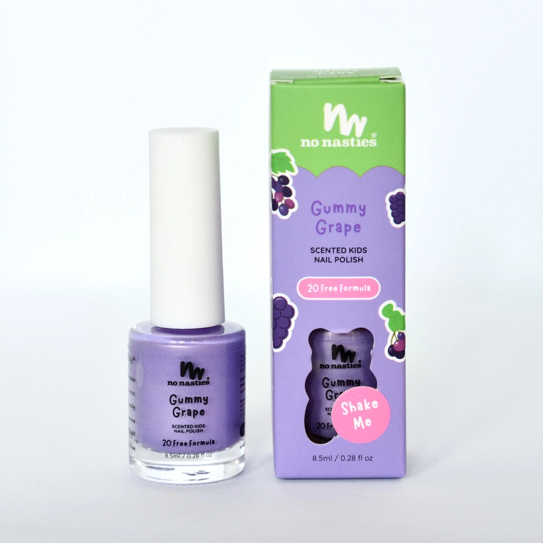 A bottle of NO NASTIES Scented Scratch Off Kids Nail Polish in Gummy Grape/Purple stands beside its box with grape graphics and "20 Free Formula" and "Shake Me" text.