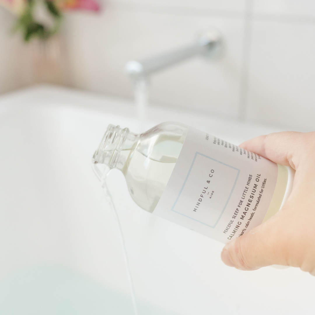 Mindful & Co calming magnesium oil being tipped out of the bottle into a bath.