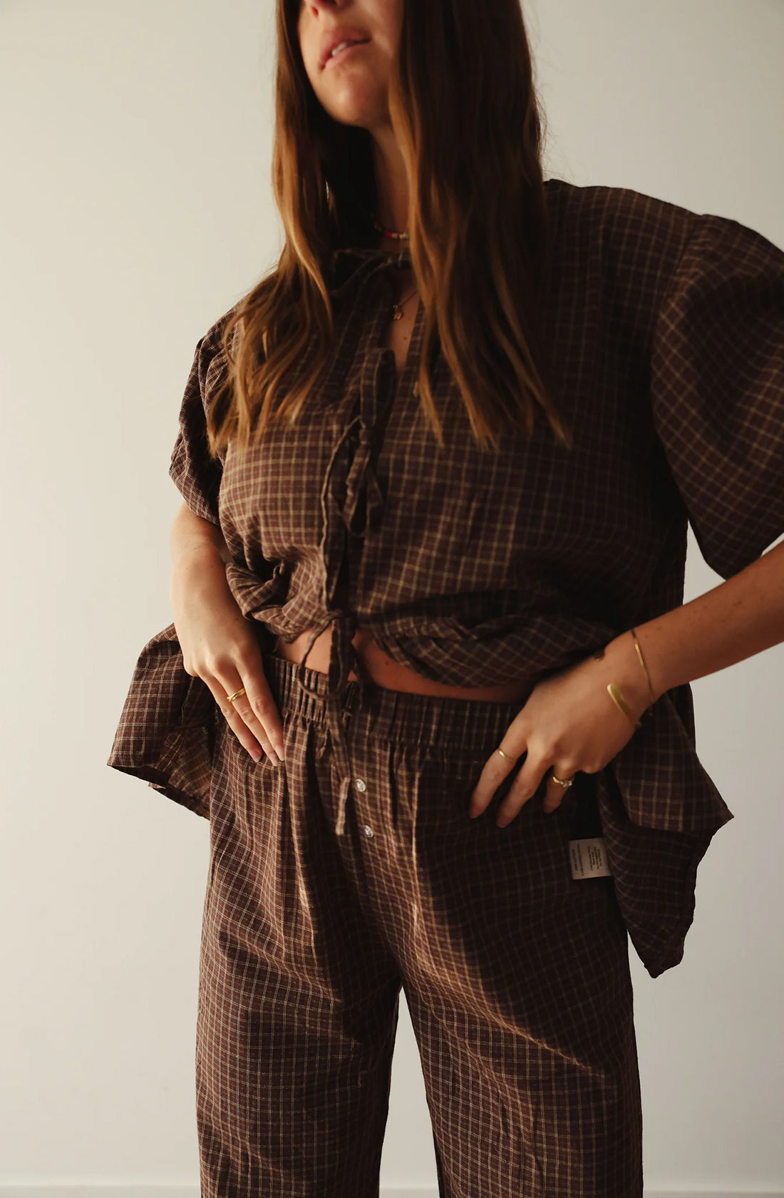 A women wearing the mama cami blouse and matching pant.