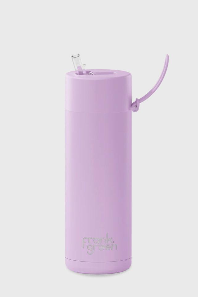 The FRANK GREEN Ceramic Reusable Bottle 595ml 20oz in Lilac Haze is a sleek, tall reusable bottle featuring a pastel purple color. It comes with a flip-top lid and metal straw, with the brand name "FRANK GREEN" embossed near the base. This BPA-free bottle boasts a modern minimalist design and triple-wall vacuum insulation for maximum temperature retention.