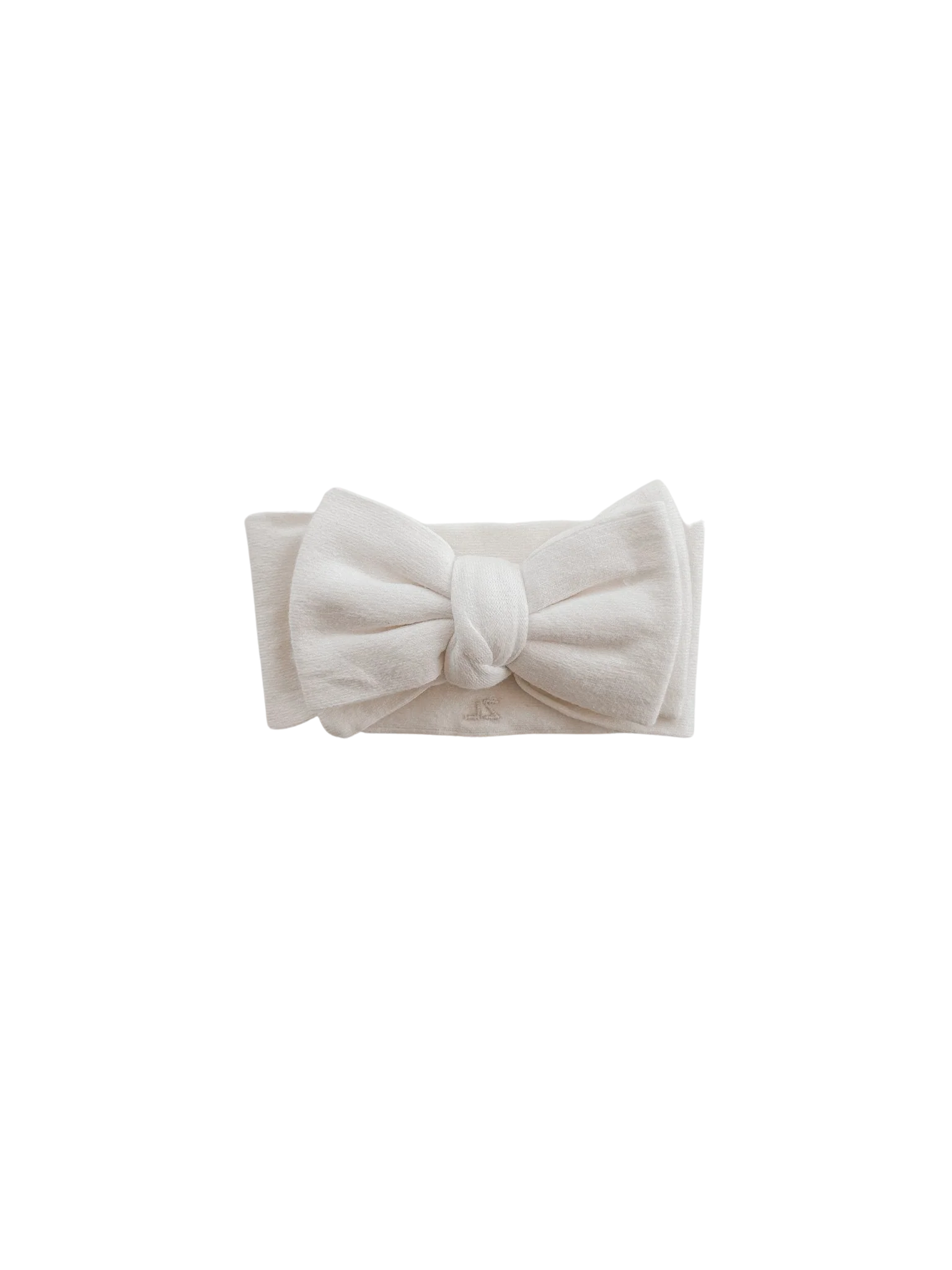 The Ziggy Lou - Headband Milk by ZIGGY LOU is a soft white thin knit headband with a large, neatly tied bow at the front, showcased on a plain black background. Part of the Milk Signature Collections and ethically made in China.