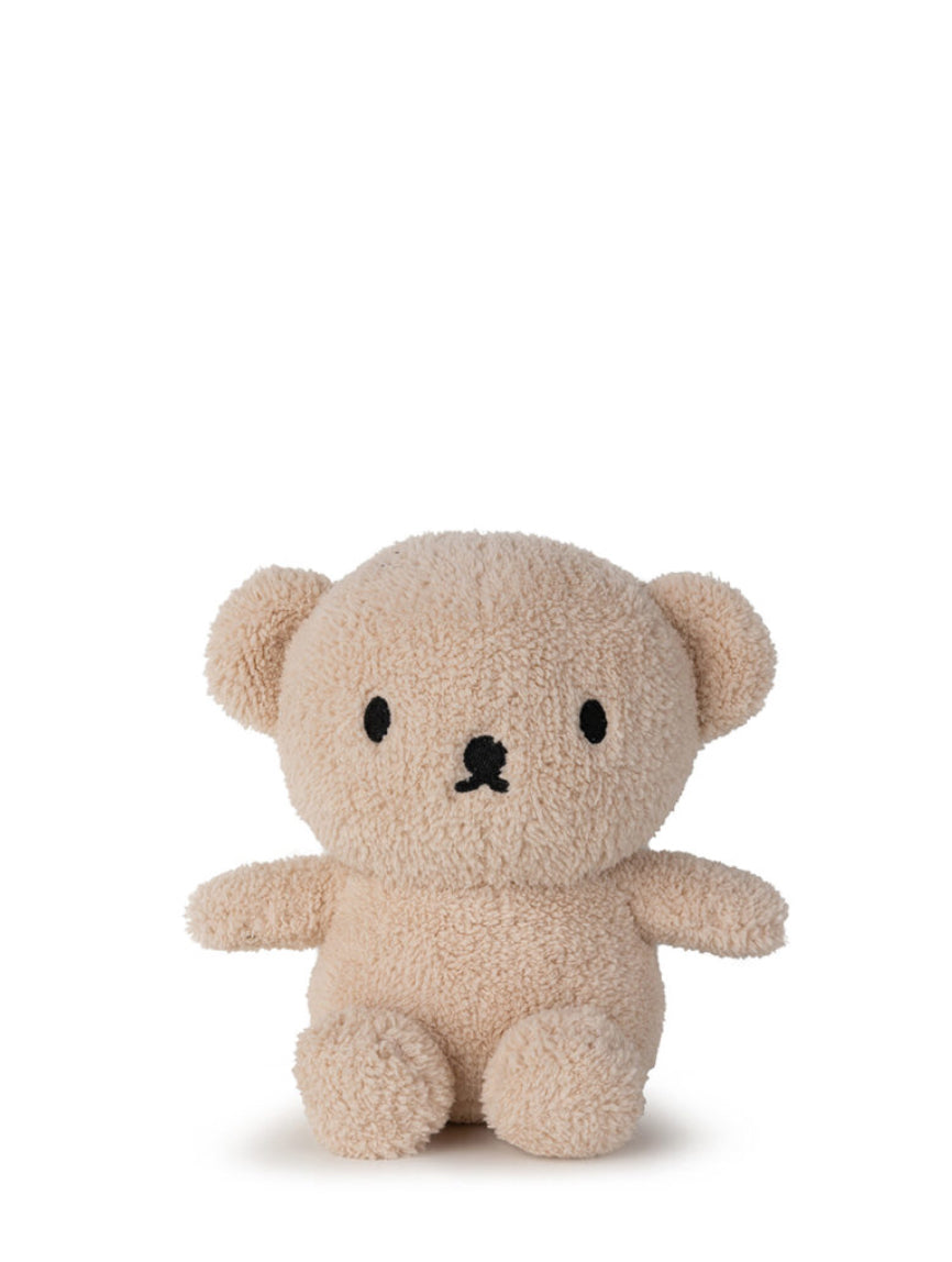 A plush teddy bear from the BON TON TOYS X MIFFY collection, Boris Bear Sitting Terry Beige 23 cm, features light beige, fluffy and textured fur. It sits upright against a plain white background. The adorable Boris Bear boasts small, round ears, black button-like eyes, and a simple black stitched nose and mouth, making it an ideal baby gift with its minimalist charm.