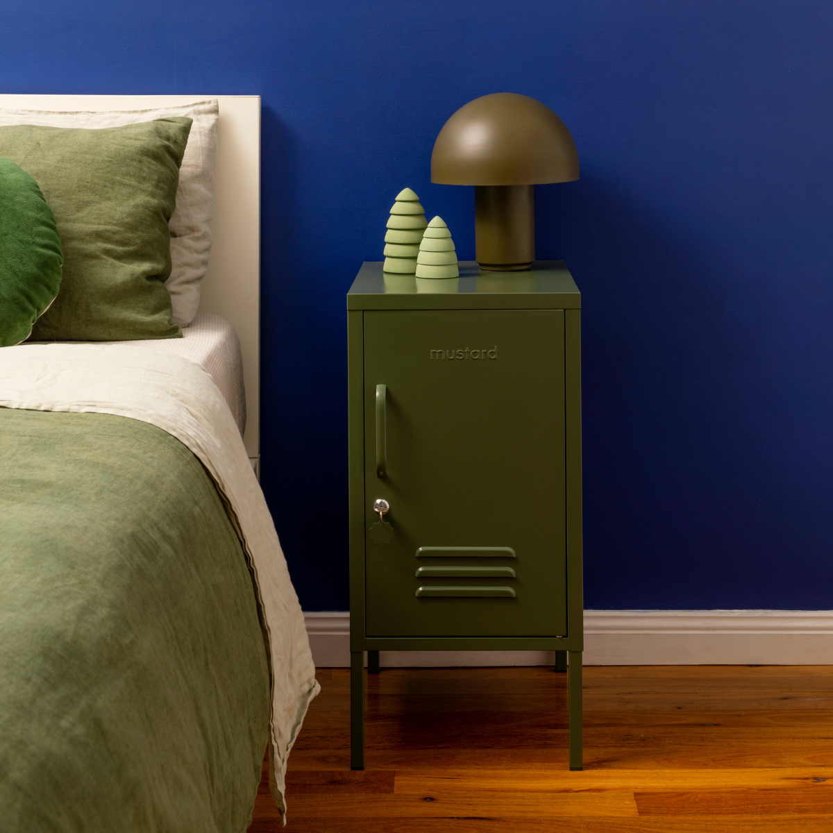 The shorty (to the right) locker in olive next to bed.