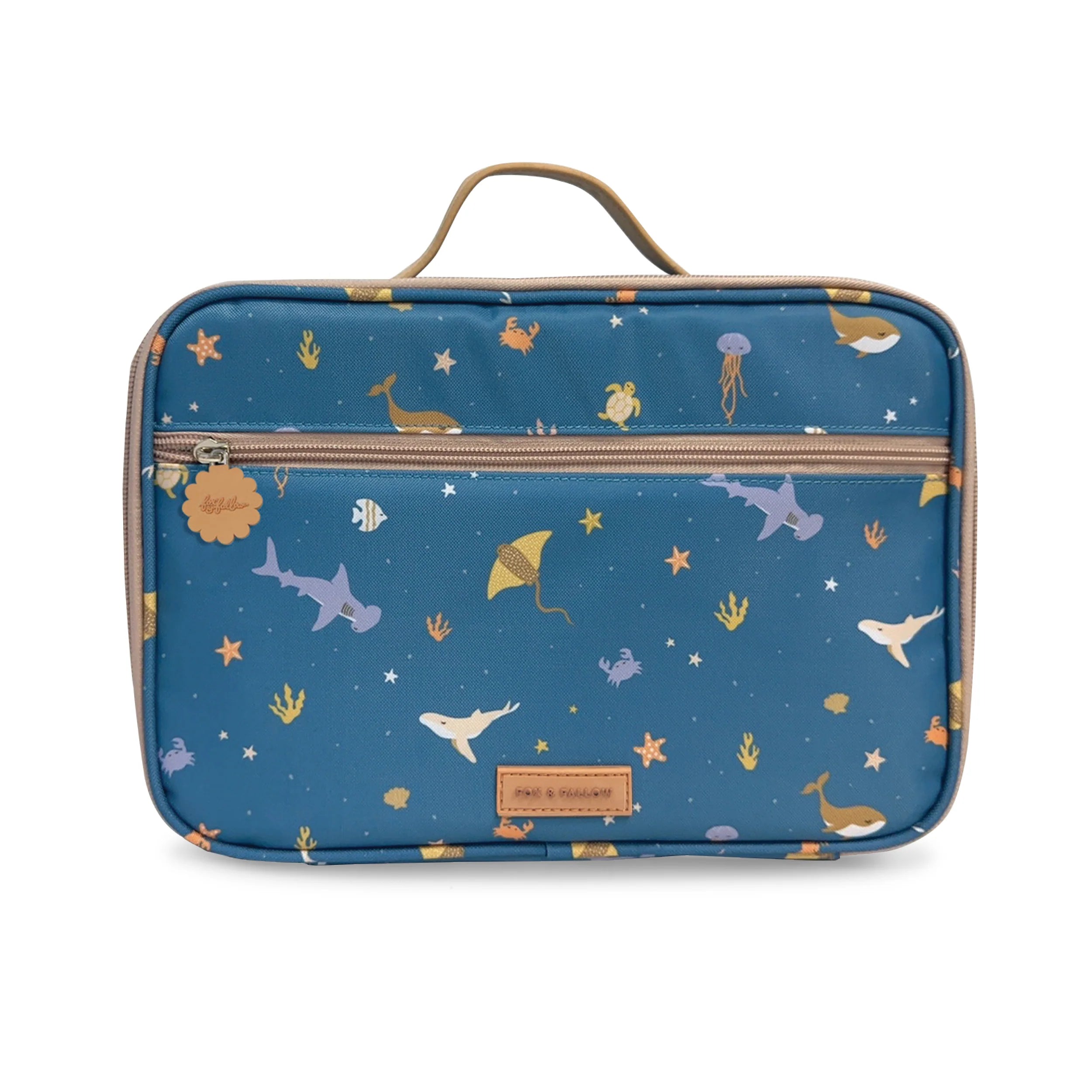 The Ocean Creatures Marine Lunch Bag by FOX & FALLOW is a blue rectangular travel accessory adorned with playful underwater-themed prints, including sharks, whales, rays, and starfish. Crafted from waterproof fabric, it features a top handle, a front zipper pocket, and a brown leather patch on the front—making it an ideal choice for use as one of those stylish insulated lunch bags.